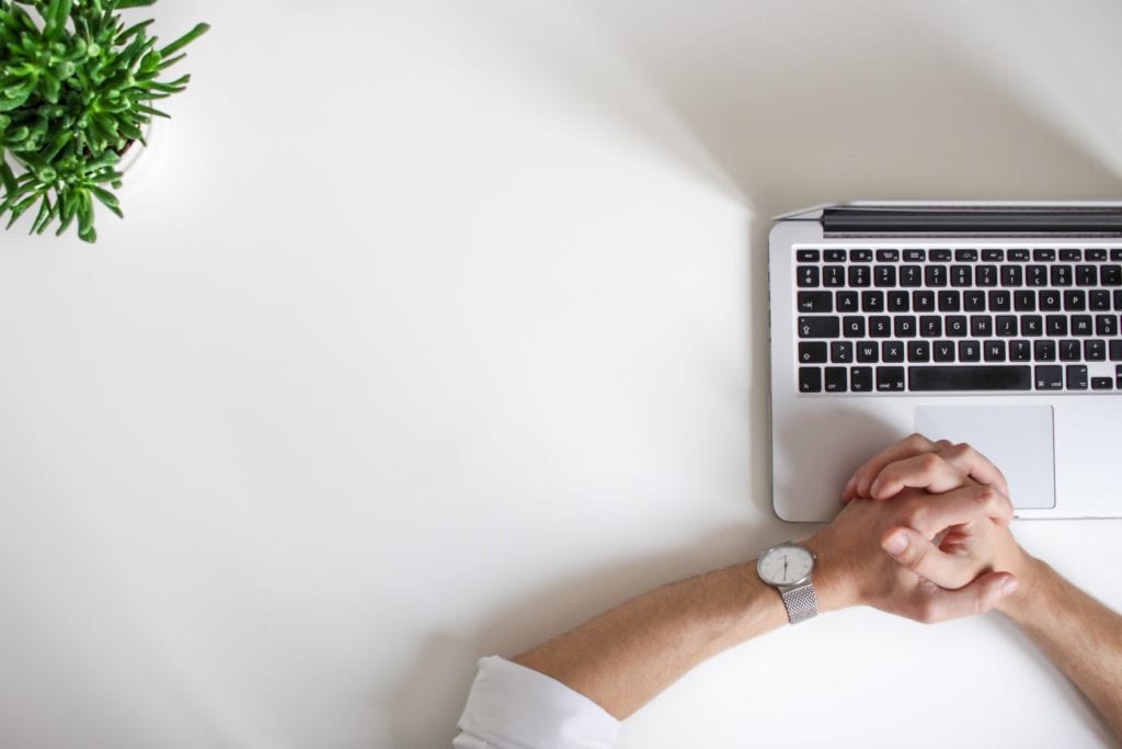 case interview market sizing framework. This picture depicts a white desk with a laptop siting on it.