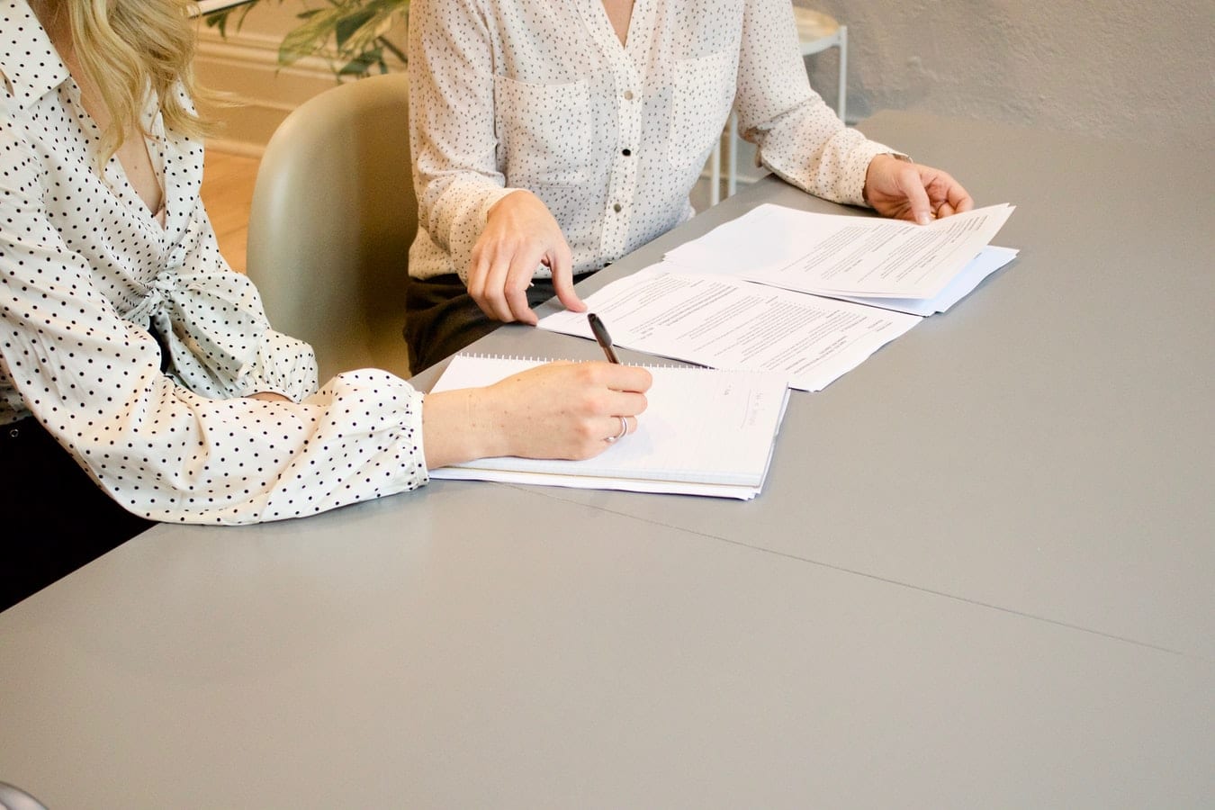 management consulting resume. Picture shows consulting recruiters reviewing resumes.